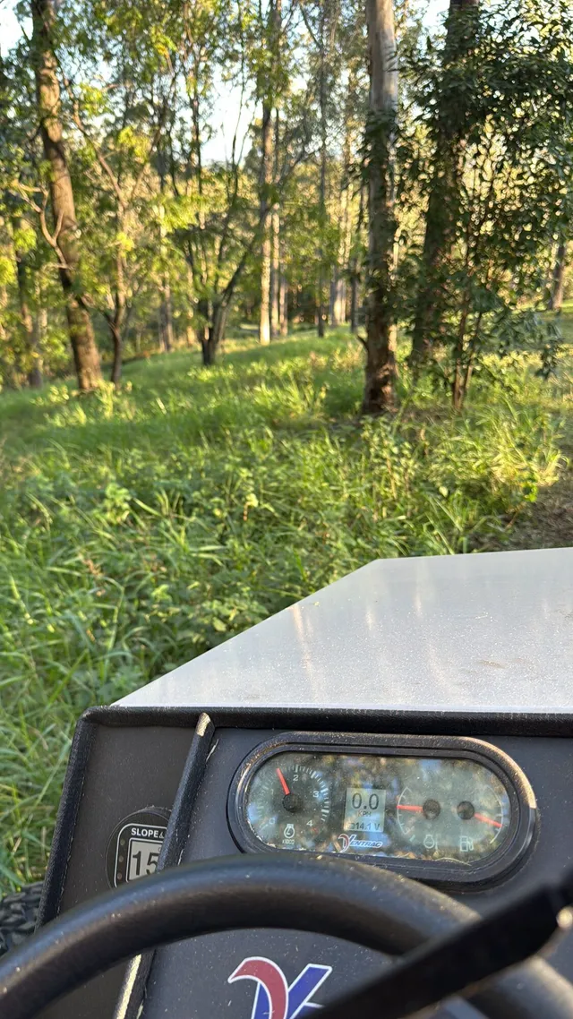 View from the Ventrac cab with the on-board slope meter while assessing a wooded slope, Pullenvale