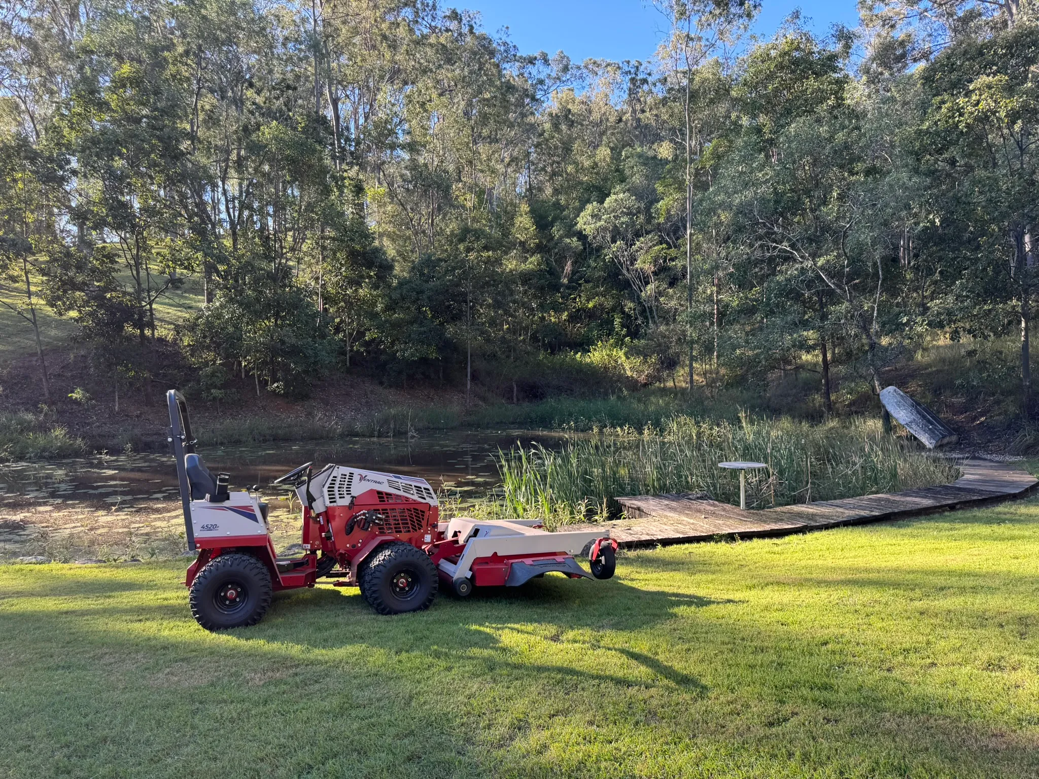 Ventrac 4520P beside a reed-fringed farm dam after mowing the banks