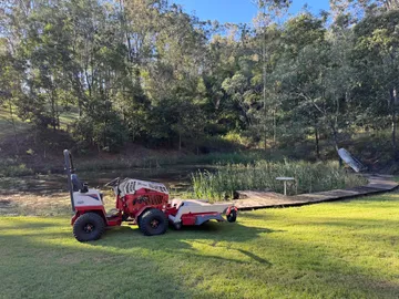 Ventrac 4520P beside a reed-fringed farm dam after mowing the banks