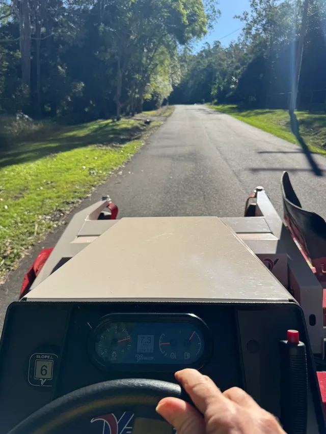 Operator's view from the Ventrac cab driving along a sealed rural road on the way to a job, Pullenvale