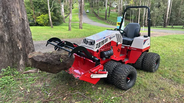 Ventrac 4520P with rock grapple attachment clearing surface rock from a slope, Pullenvale