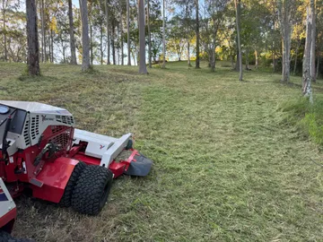 Ventrac 4520P slashing tall grass beside a farm dam